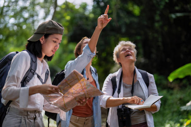istock Backpack tourist travel outdoor adventure bird study using binoculars looking and record to book 1438145992