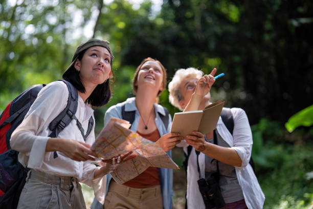 istock Backpack tourist travel outdoor adventure bird study using binoculars looking and record to book 1438146123