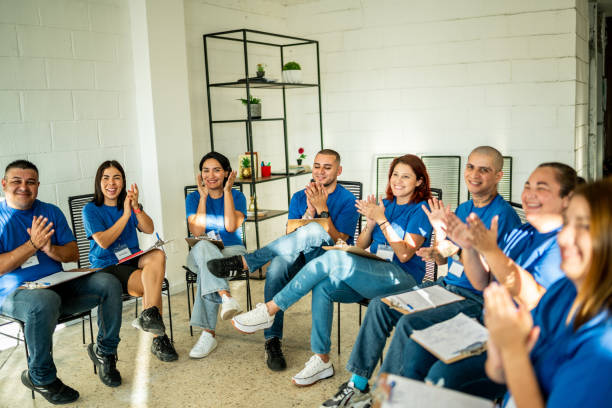 istock Volunteers clapping during a presentation at community center 1438146336