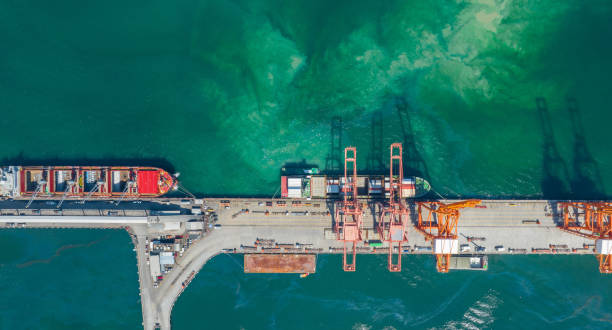 istock Cargo container Ship under Big crane load container box to truck at Bridge Cargo Shipyard Container ship under the crane Sea Port service logistics and transportation. International Shipping Depot Customs Port for import export trade. 1438146915