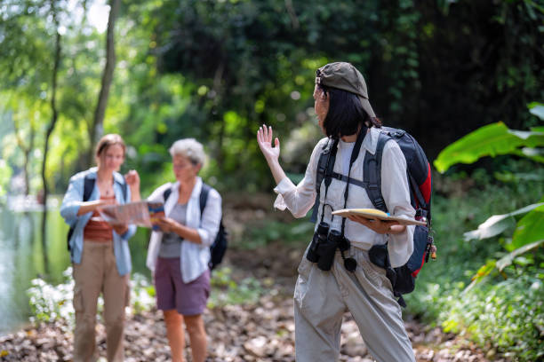 istock Backpack tourist travel outdoor adventure bird study using binoculars looking and record to book 1438147211