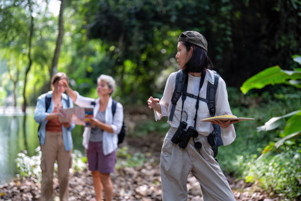 istock Backpack tourist travel outdoor adventure bird study using binoculars looking and record to book 1438147214