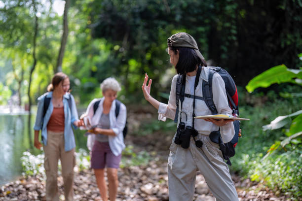 istock Backpack tourist travel outdoor adventure bird study using binoculars looking and record to book 1438147243