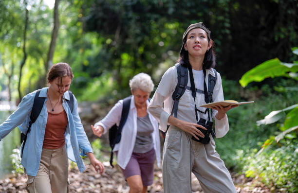 istock Backpack tourist travel outdoor adventure bird study using binoculars looking and record to book 1438147362
