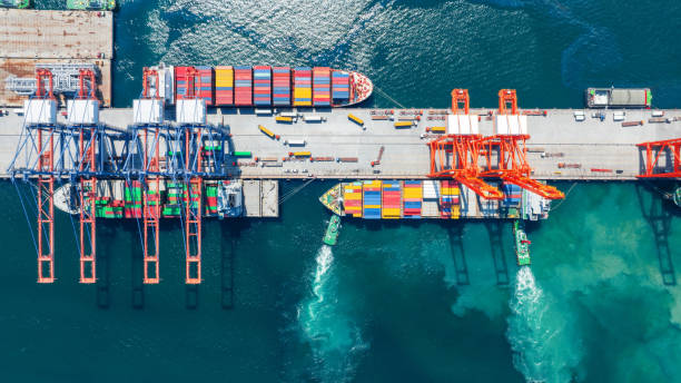 istock Tug boat drage pull Cargo container Ship to Bridge of Cargo Shipyard Container ship under the crane Sea Port service logistics and transportation. International Shipping Depot Customs Port for import export trade. 1438147535
