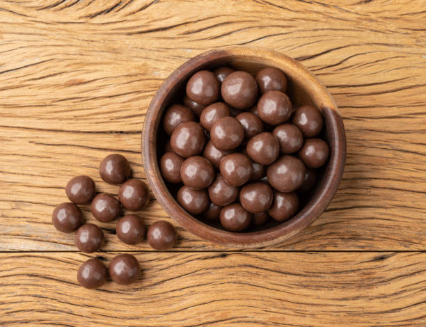istock Chocolate malted balls on a bowl over wooden table 1438148017