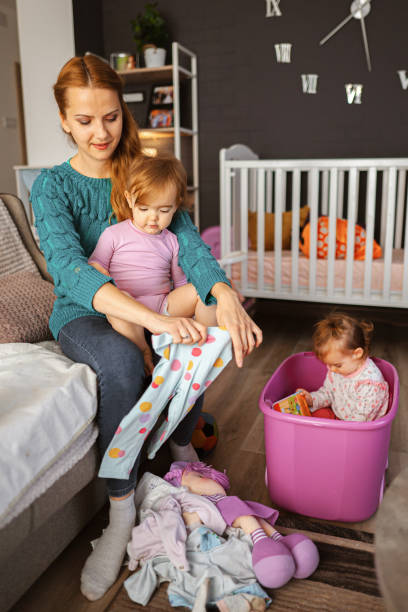 istock Happy loving mother with her twin daughters 1438149557