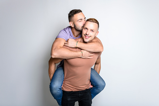 The Two young men couple over white background on studio