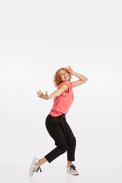 istock Excited beautiful young redheaded woman dancing isolated on white studio background. Human emotions, facial expression, beauty concept. 1438151213