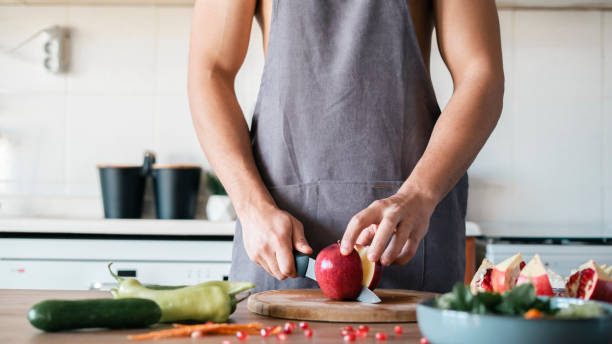 istock Half naked man with kitchen apron preparing his meal 1438151643
