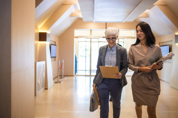 istock Businesswoman entering a hotel with her assistant 1438152773