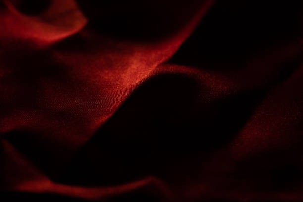 Red bed linen gradient texture blurred curve style of abstract luxury fabric,Wrinkled bed linen and red shadows,background, cloth detail stock photo