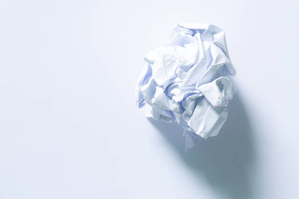 crushed paper,crumbled white paper ball, isolated on white