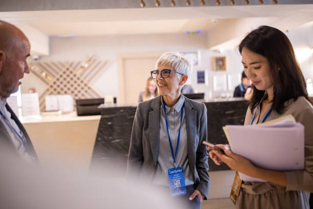 istock Business conference attendees socializing in a hotel's lobby while waiting for the conference to start 1438154065