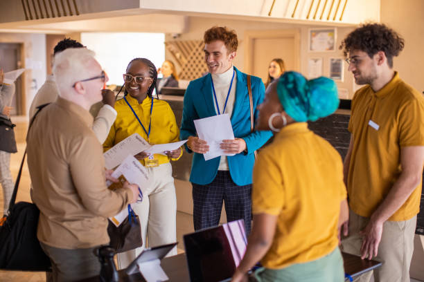 istock Business people registering for a conference event in a hotel lobby 1438155372