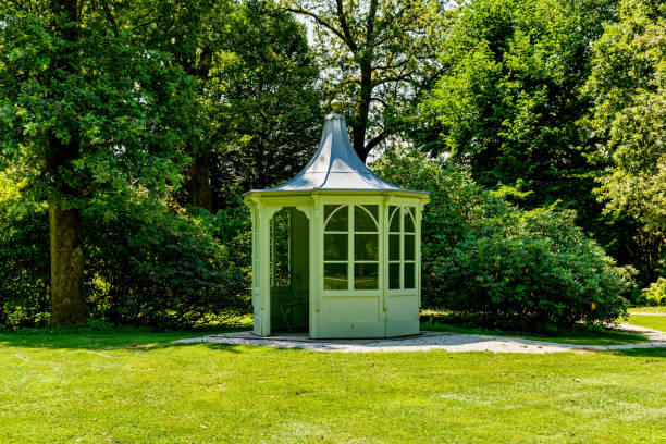 istock Small pavilion in a park with beautiful green trees 1438155477