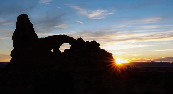 Turret Arch silhouette in last rays of sunset. Arches National Park, Utah.