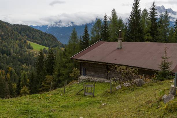 istock House built in between a valley surrounded by trees and grasss 1438156238