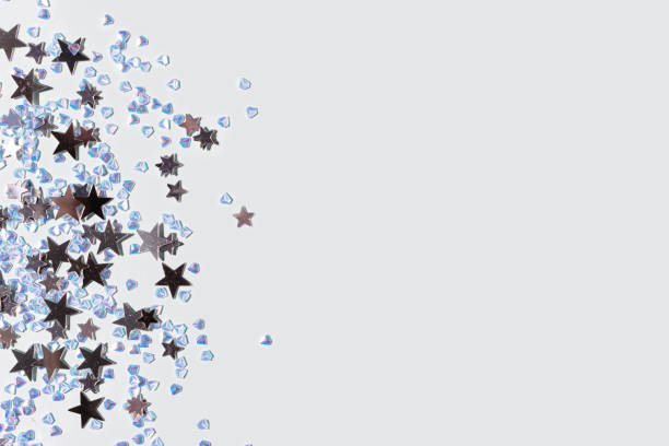 istock Shiny silver stars and crystals confetti on a blue background. 1438157297