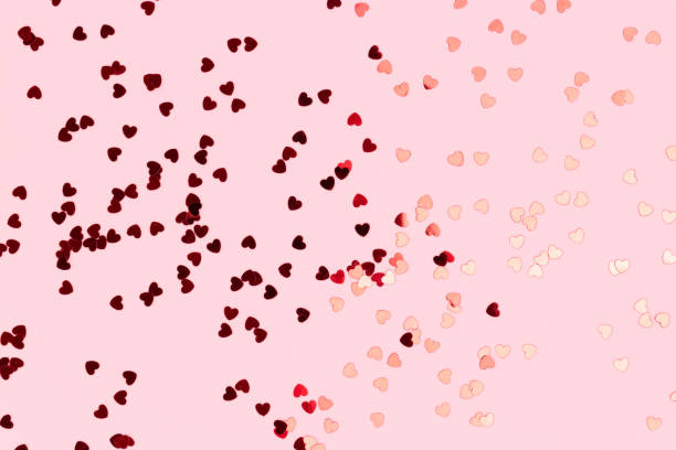 istock Metallic red confetti in a heart shaped. 1438157420