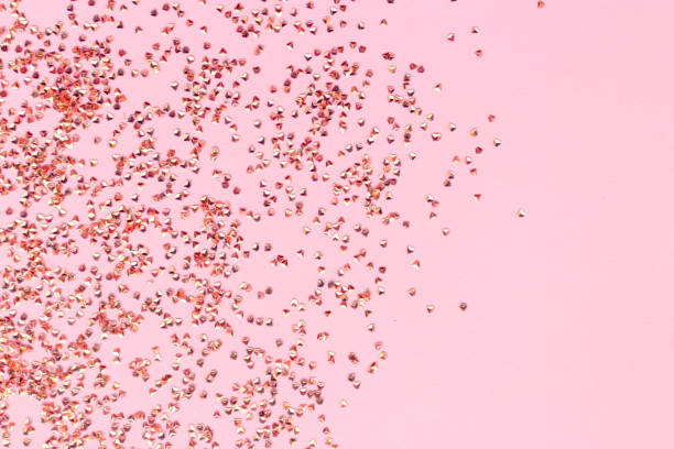 istock Shiny crystals confetti texture on a pink background. 1438157433