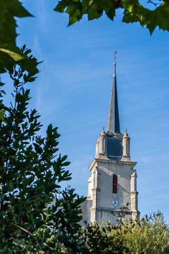 les moutiers, France – July 23, 2022: A vertical shot of a church in the town center in Les Moutiers, France