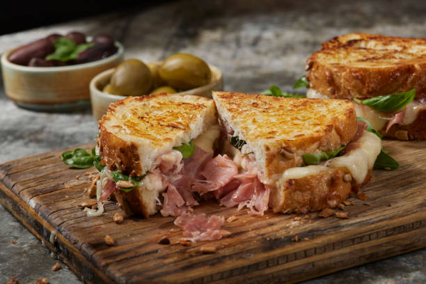 Grilled Cheese with Prosciutto and Brie Grilled Cheese with Prosciutto, Brie and Fresh Basil toasted sandwich stock pictures, royalty-free photos & images