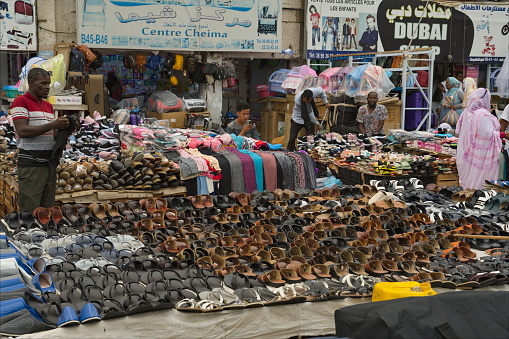 Nouakchott. Mauritania. October 09, 2021. A local vendor sells a huge number of sneakers of different types and sizes at the central street market.