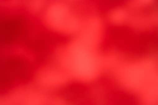 Red defocused abstract smooth asymmetric gradient background