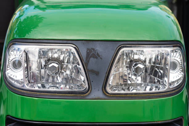 Front lighting bars of a small green tractor. Close up.
