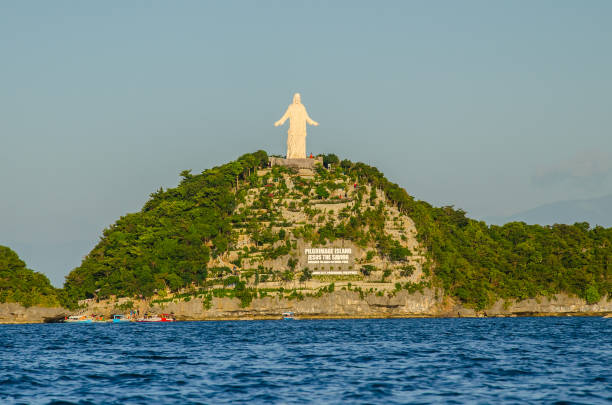 Mesmerizing shot of Christ the Savior statue in Hundred Island, Alaminos, Pangasinan A mesmerizing shot of Christ the Savior statue in Hundred Island, Alaminos, Pangasinan pangasinan stock pictures, royalty-free photos & images