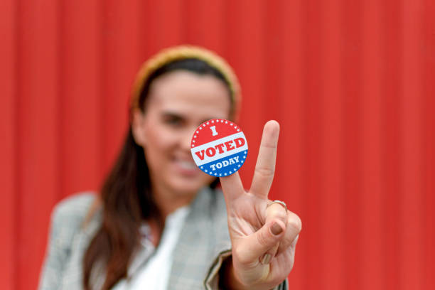 istock Young woman holding voting badge, sticker. 1438168227