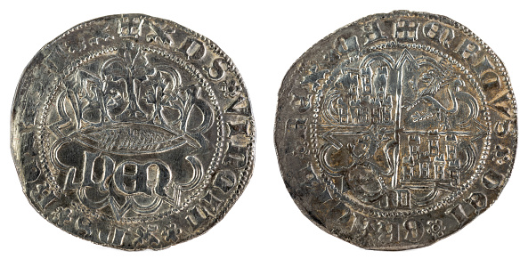 The front and backside of a historic medieval silver coin of the King Enrique IV