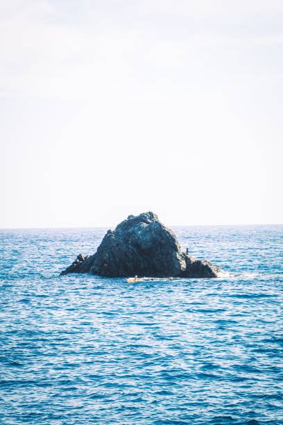 istock Vertical shot of a massive rock in the sea 1438169070