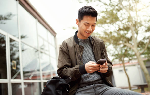 istock Smartphone, campus and student on university website, course information or email communication mobile app for study results or feedback. International college asian using phone for about us or faq 1438170644