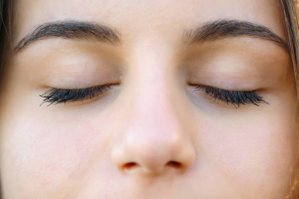 istock Close up of young woman's closed eyes 1438172476