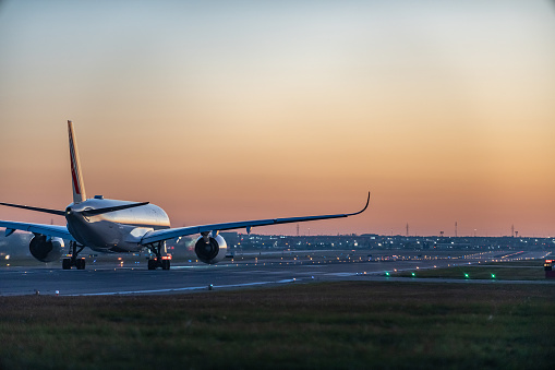 An airplane of Air France taxiing on runway in Pearson International airport at dusk, Toronto,Canada.