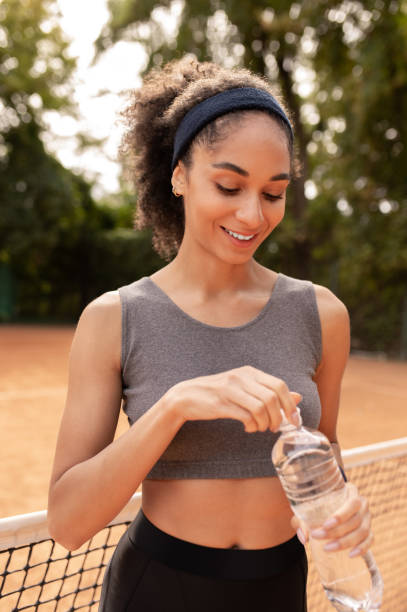 istock Cute young girl feeling thirsty after workout 1438174097