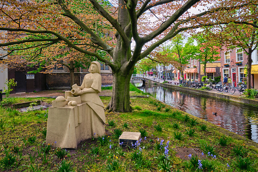 Delft, Netherlands - May 12, 2017: The Milkmaid Het Melkmeisje statue made to commemorate Vermeer's three hundredth anniversary of death, based on the painting of the same name by Vermeer