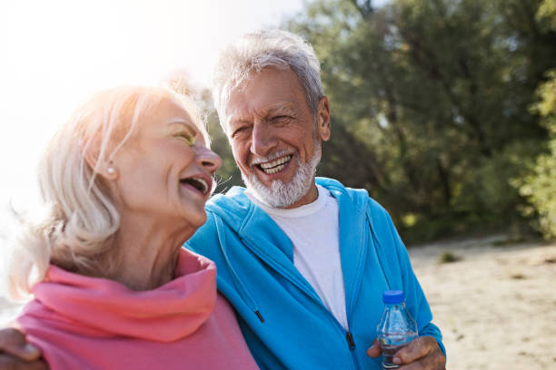 istock Senior couple having fun in park 1438176106