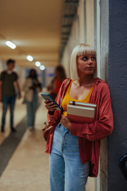 istock Female student waiting in hallway. 1438176387