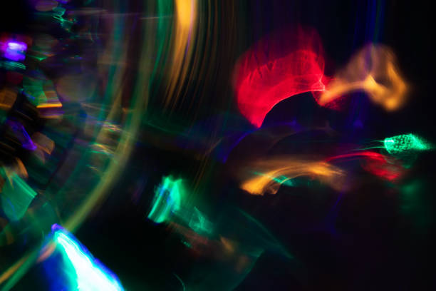 istock Blurred Light painting one exposure in camera. light glares with a spectral gradient on a dark background. 1438176800