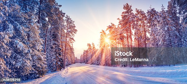istock Beautiful view of the sunrise in the morning on the country snowy road. 1438178298