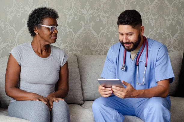 istock Doctor talking to his patient during home consultation. 1438179225