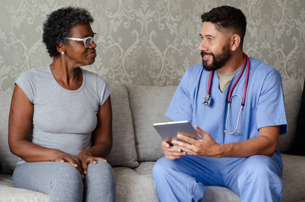 istock Doctor talking to his patient during home consultation. 1438179229