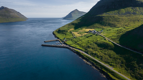 Beautiful aerial view of Sydradalur port and village near the Seal woman statue in the Faroe Islands