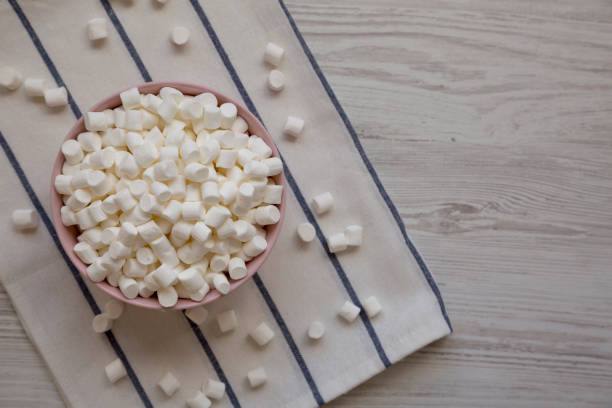 istock White Mini Marshmallows in a Pink Bowl, top view. Flat lay, overhead, from above. 1438179699
