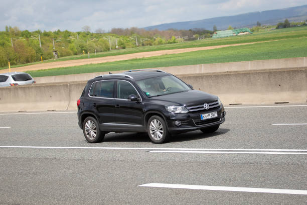 Diedenbergen, Germany - May 06, 2021: VW Tiguan on a highway nearby Wiesbaden, Germany. The VW Tiguan is a compact SUV and produced since 2007. VW is a brand of the Volkswagen Group, which is a German automobile manufacturing group based in Wolfsburg, Germany and founded in 1937