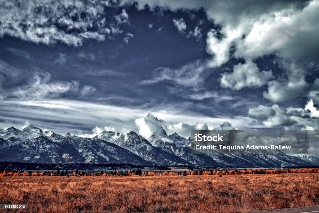 Rushing clouds over the grand Storm clouds breaking over the grand Teton Scenics - Nature Stock Photo
