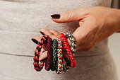 Woman holding hair ties elastics in diffrent colors new close up